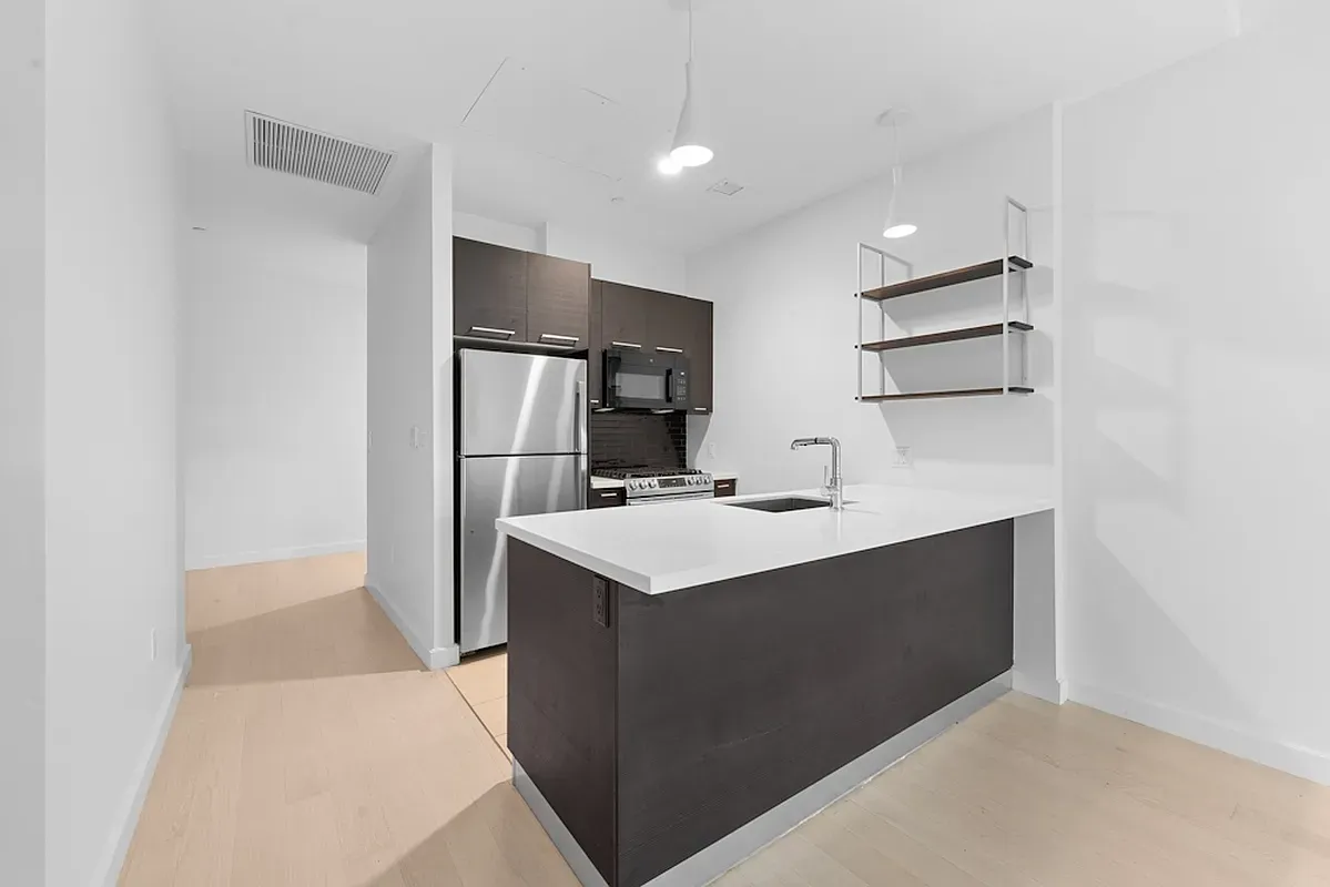 a kitchen with kitchen island a sink appliances and cabinets