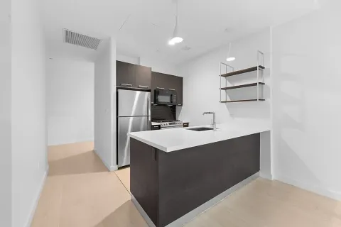 a kitchen with kitchen island a sink appliances and cabinets