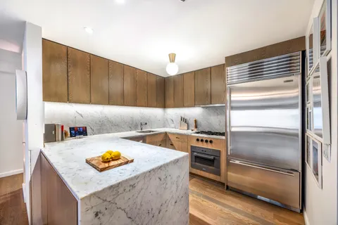 a kitchen with a refrigerator and a sink