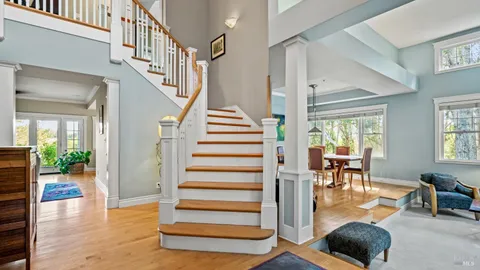 a view of entryway and hall with wooden floor