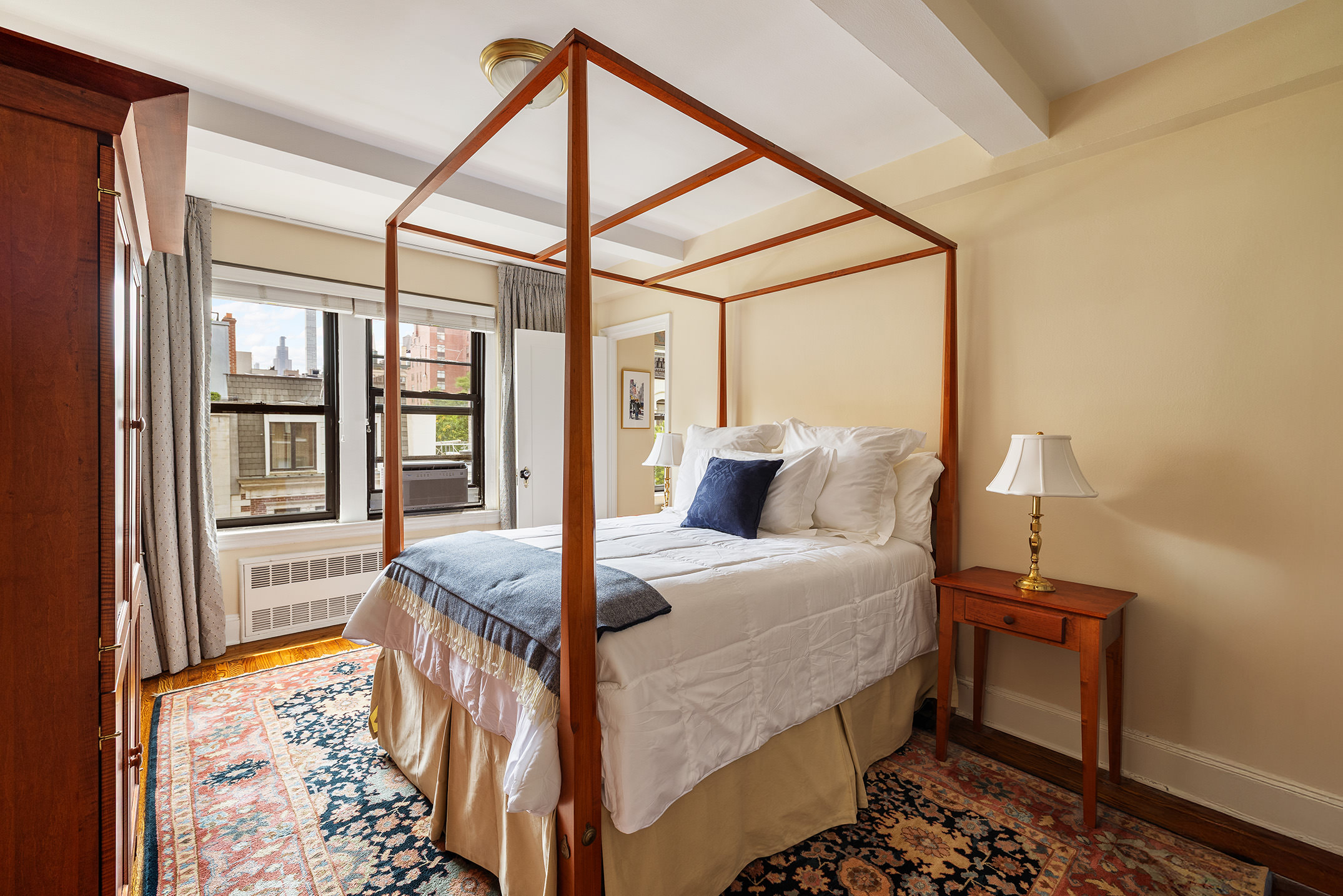 151 East 83rd Street, Unit 6D Manhattan, NY 10028 - Photo 7 of 14 a bedroom with a bed and wooden floor