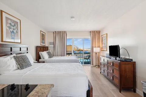 a very nice looking room with a large window and a wooden floor