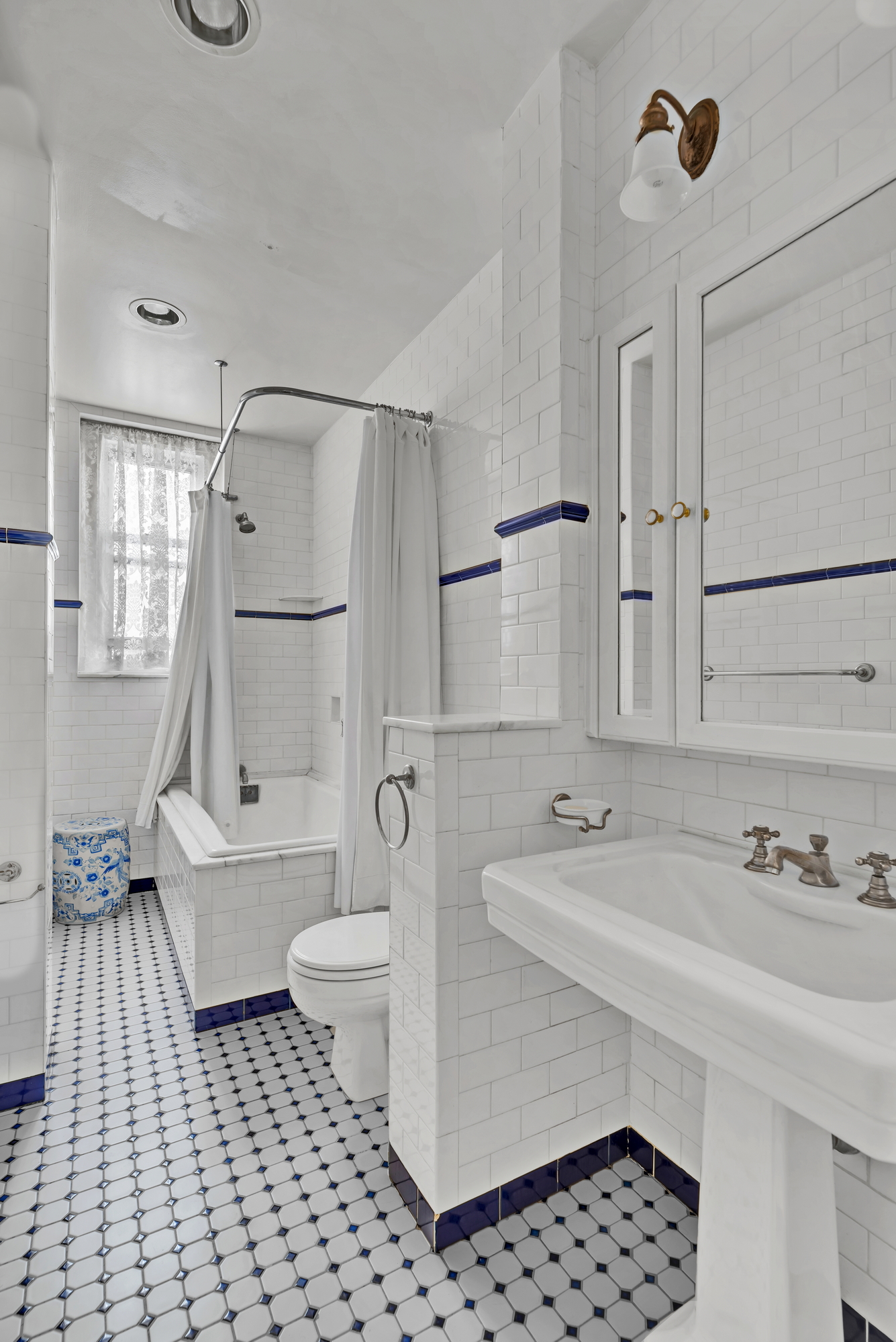 455 East 51st Street, Unit 6B Manhattan, NY 10022 - Photo 9 of 17 a bathroom with a sink a toilet and shower