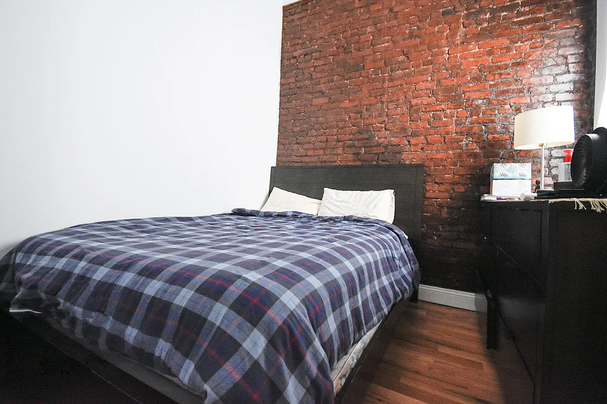 199 Java Street Brooklyn, NY 11222 - Photo 25 of 32 a bedroom with a bed and wooden floor