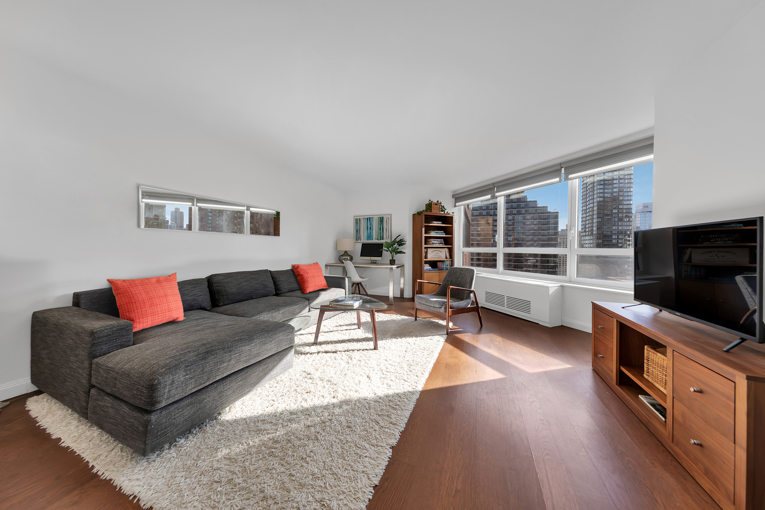 a living room with furniture and a flat screen tv
