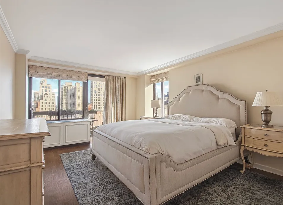 a large white bed in a white room