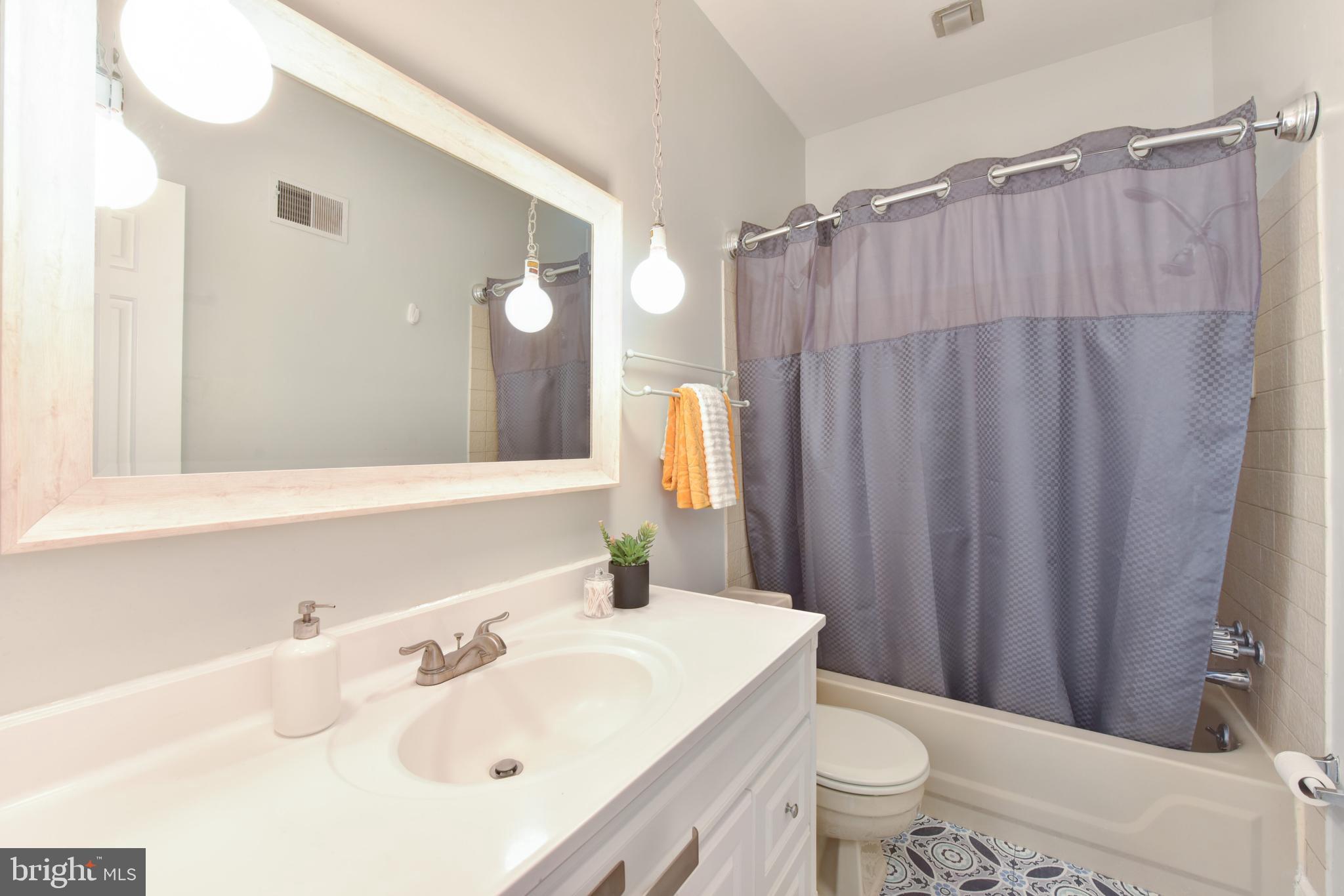 629 5th Street Northeast Washington, DC 20002 - Photo 17 of 31 a bathroom with a sink a toilet and shower curtain