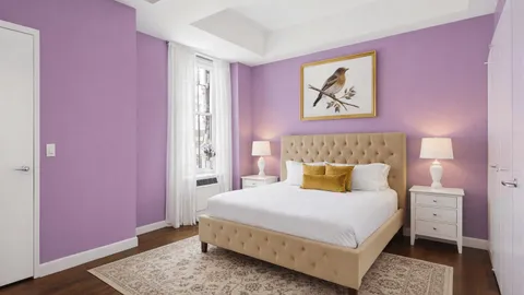 a bedroom with a bed and a painting on the wall