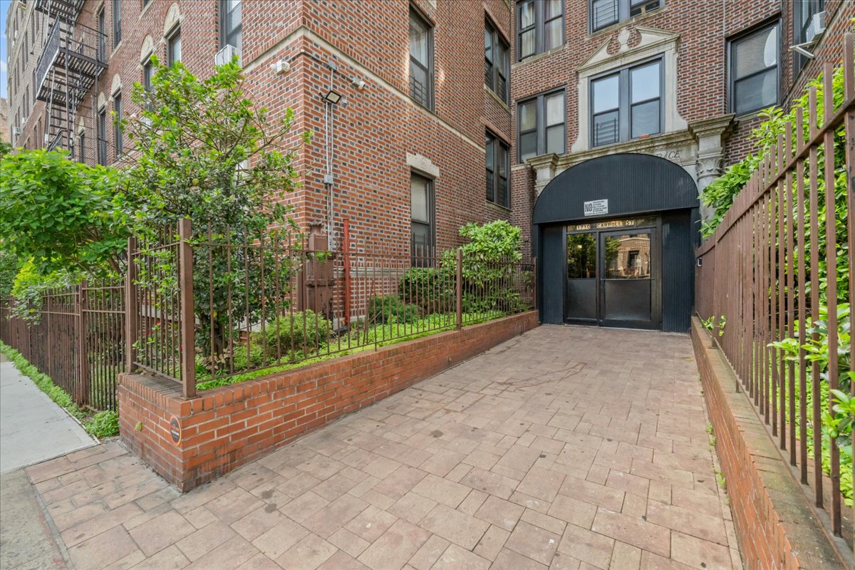 1710 Carroll Street, Unit D4 Brooklyn, NY 11213 - Photo 12 of 16 a view of a brick house with many windows next to a yard