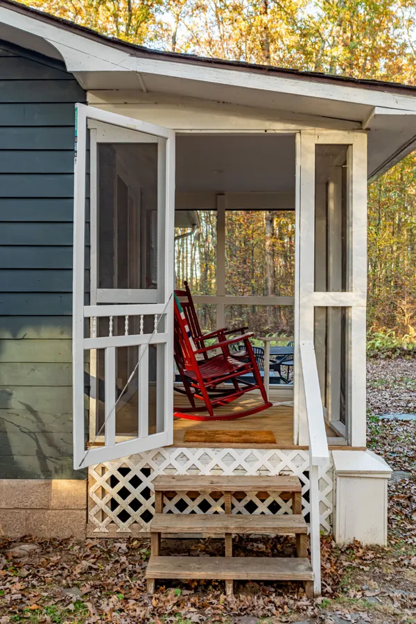 a backyard of a house with table and chairs