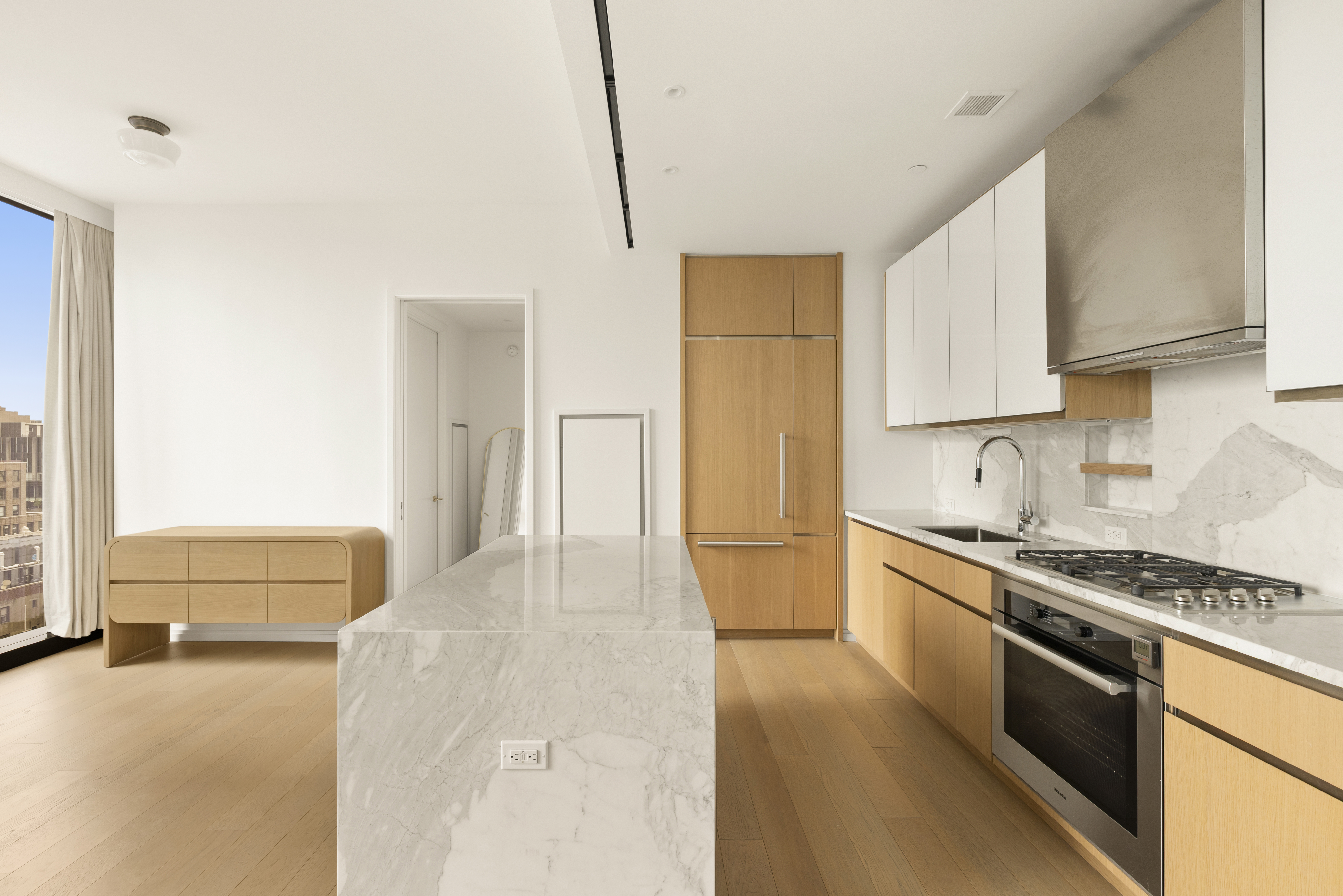 277 5th Avenue, Unit 21C Manhattan, NY 10016 - Photo 3 of 15 a kitchen with stainless steel appliances granite countertop a stove a sink and a refrigerator