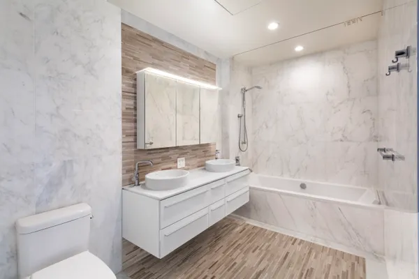 a bathroom with a sink a toilet and shower
