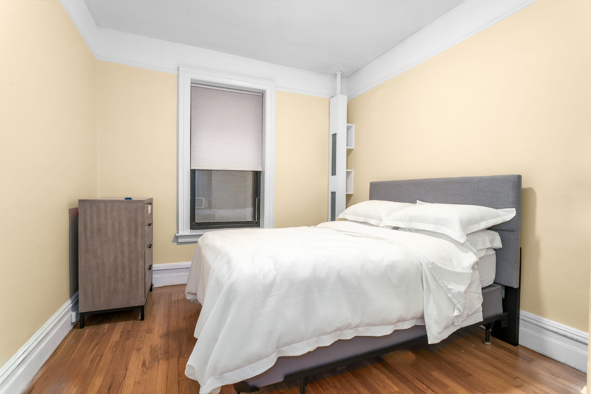 61 East 86th Street, Unit 25 Manhattan, NY 10028 - Photo 5 of 9 a bedroom with a bed and wooden floor