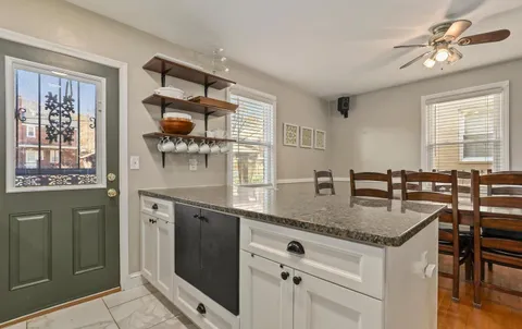 a kitchen with stainless steel appliances granite countertop a sink and a refrigerator