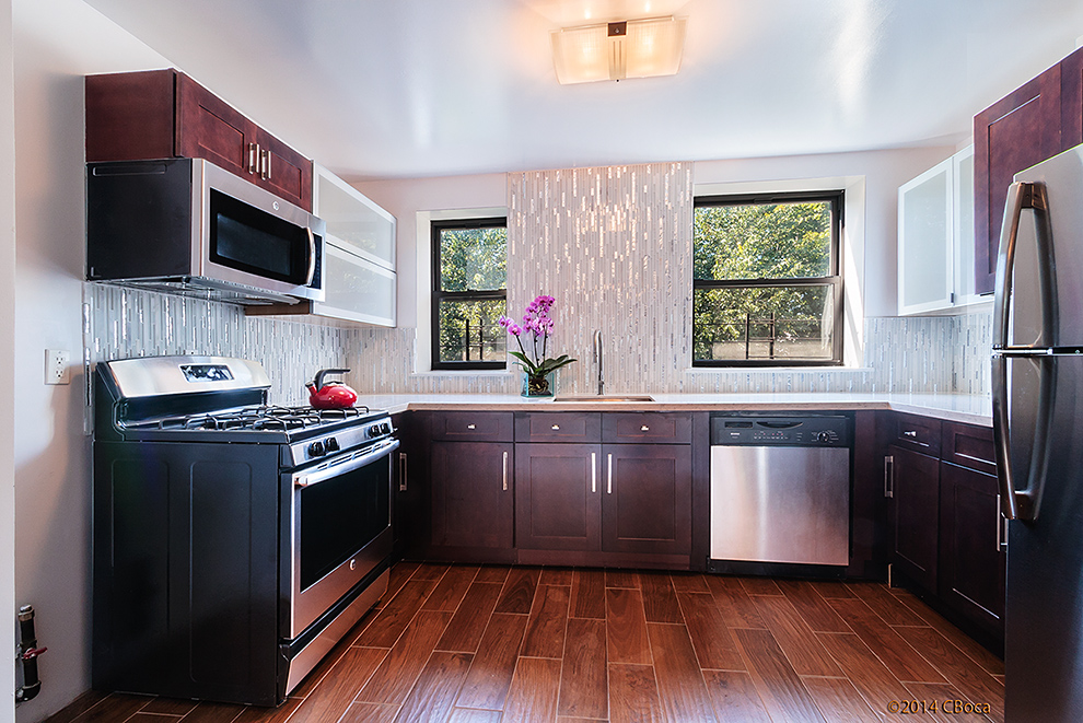 a kitchen with stainless steel appliances granite countertop a stove a sink and a microwave