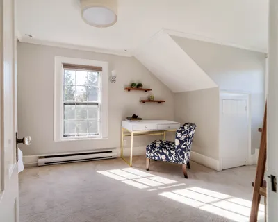 a room with furniture a rug and a window