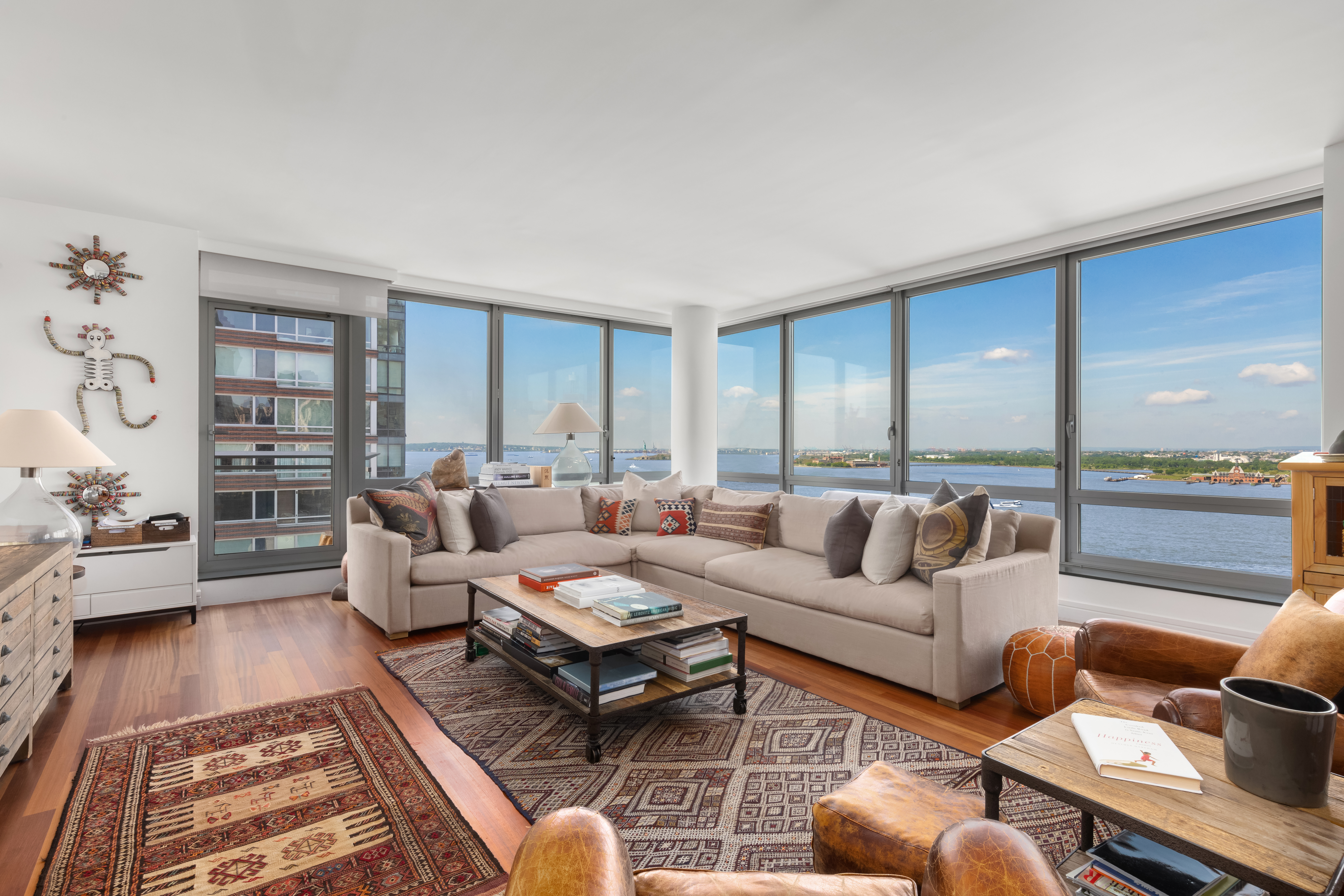30 West Street, Unit 23F Manhattan, NY 10004 - Photo 1 of 12 a living room with furniture and a large window