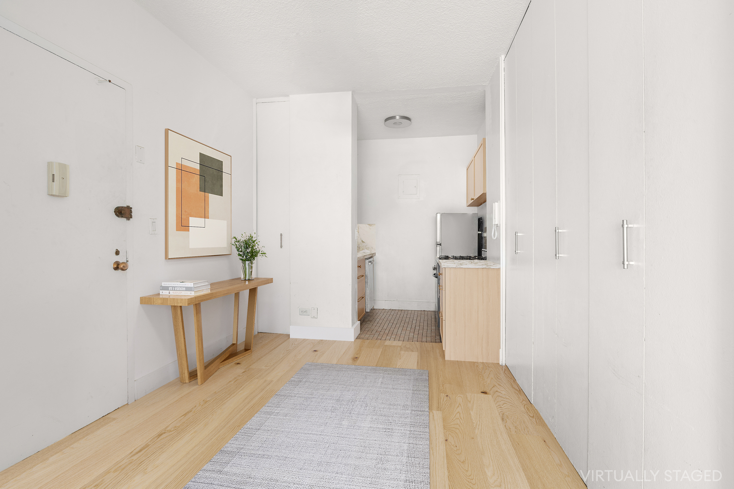 60 East 8th Street, Unit 18J Manhattan, NY 10003 - Photo 5 of 10 a bathroom with a tub sink and mirror