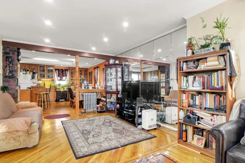 a living room with furniture and a book shelf