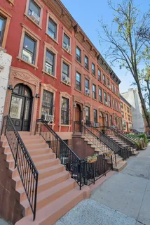 a view of a brick building next to a road