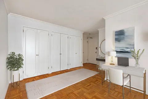 a bedroom with a bed and a potted plant