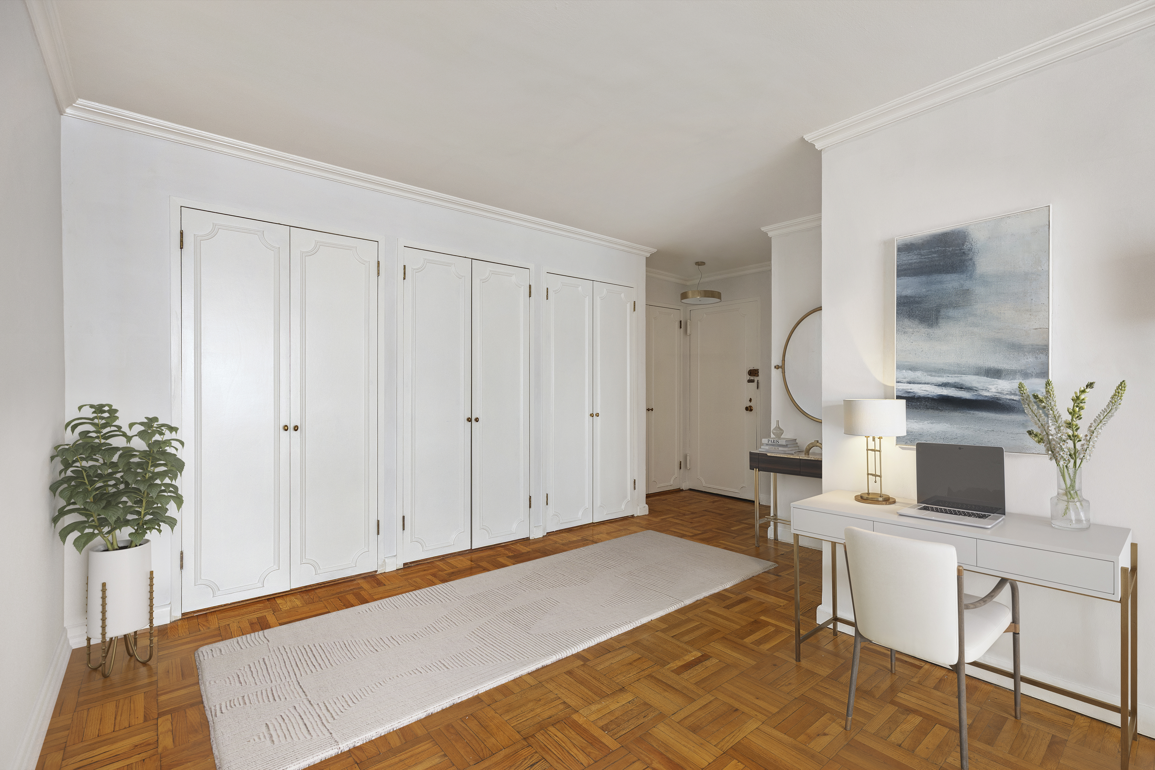 201 East 66th Street, Unit 2E Manhattan, NY 10065 - Photo 5 of 15 a bedroom with a bed and a potted plant