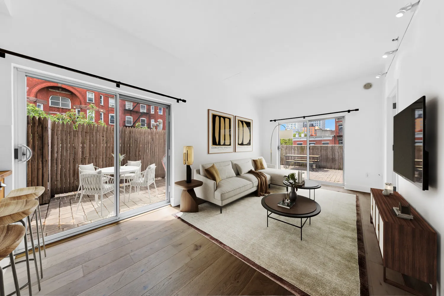 a living room with furniture a flat screen tv and a floor to ceiling window