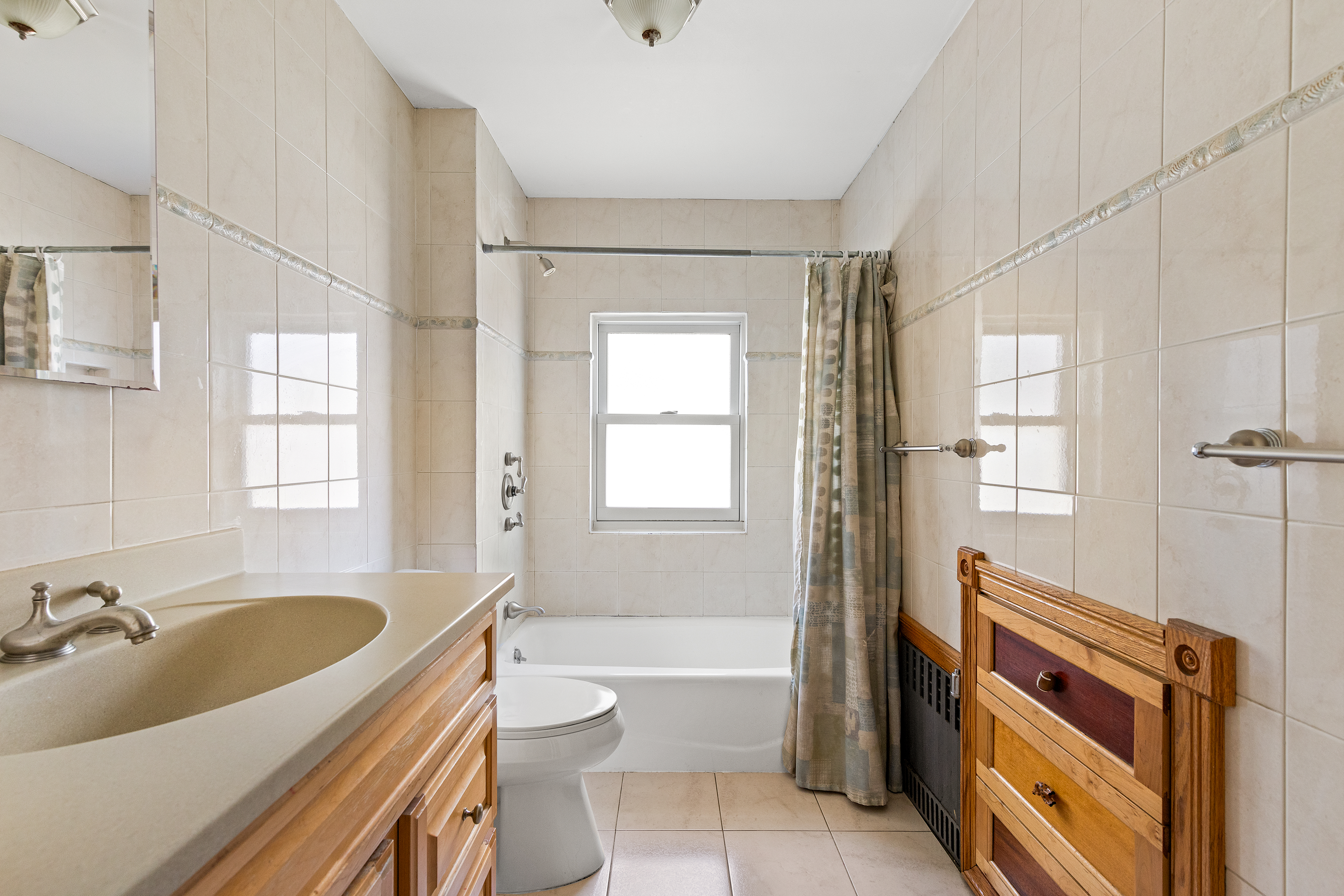 489 Marlborough Road Brooklyn, NY 11226 - Photo 16 of 21 a bathroom with a sink toilet a tub and shower