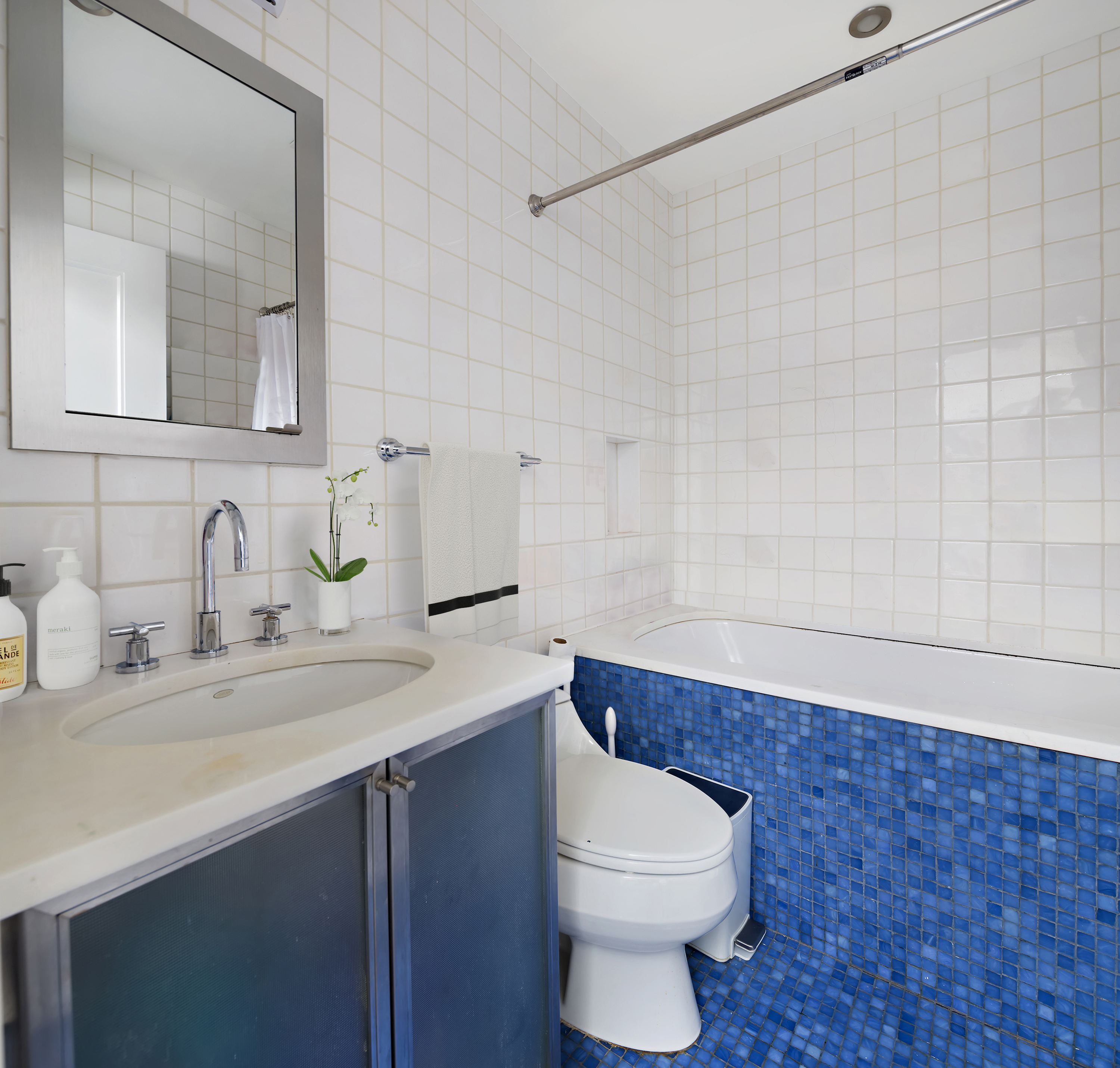83 Jane Street, Unit TH1 Manhattan, NY 10014 - Photo 23 of 29 a bathroom with a sink a toilet and mirror