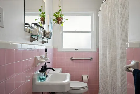 a bathroom with a sink a toilet and a window