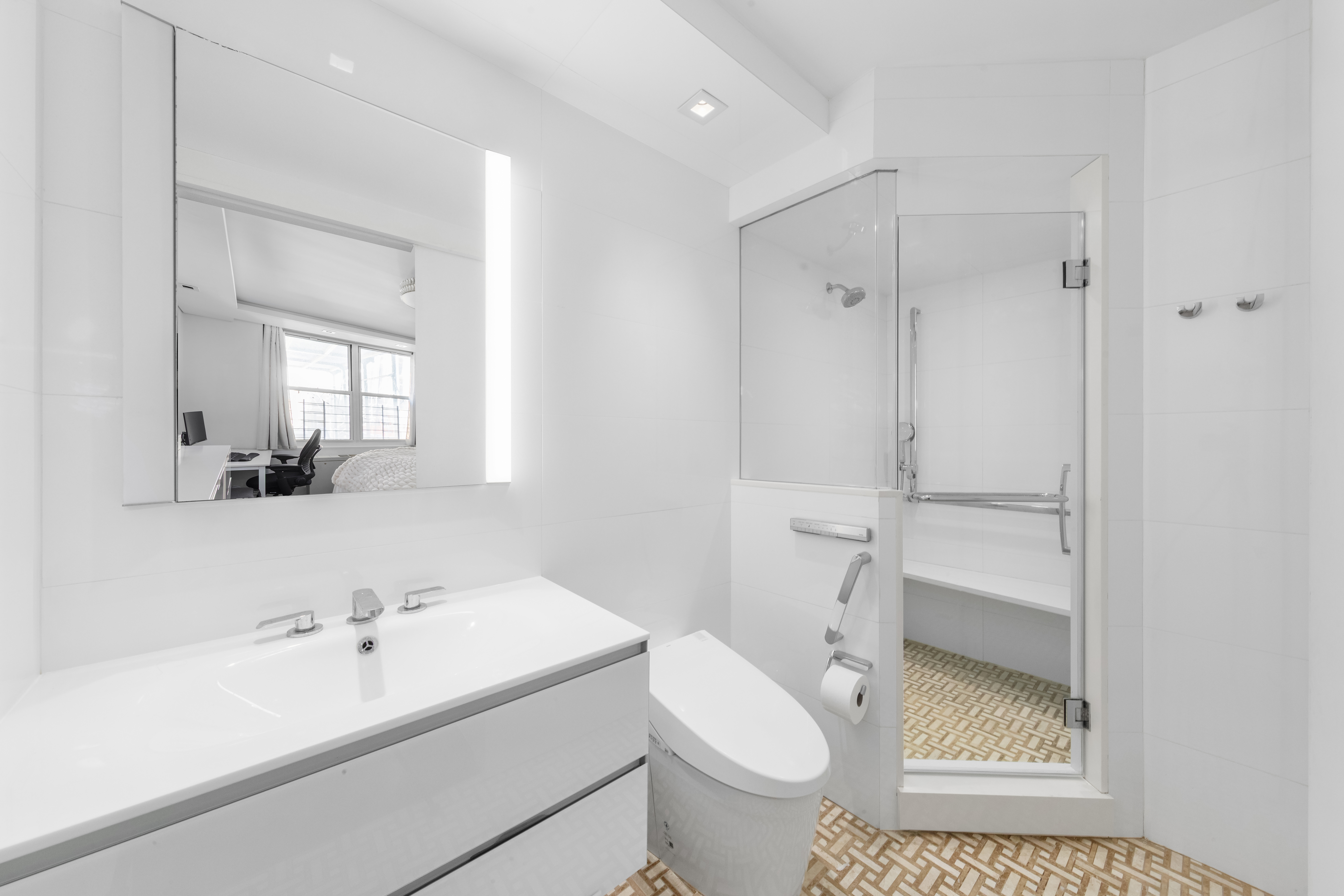 207 East 74th Street, Unit 1J Manhattan, NY 10021 - Photo 6 of 9 a bathroom with a sink a toilet and shower