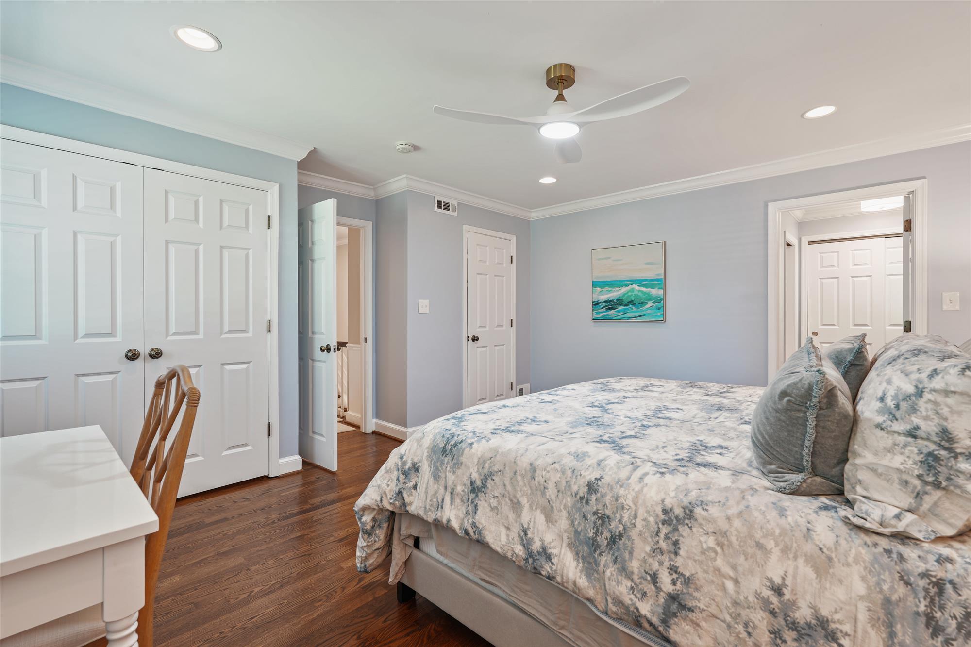 9904 Carter Road Bethesda, MD 20817 - Photo 21 of 41 a spacious bedroom with a bed and a chair