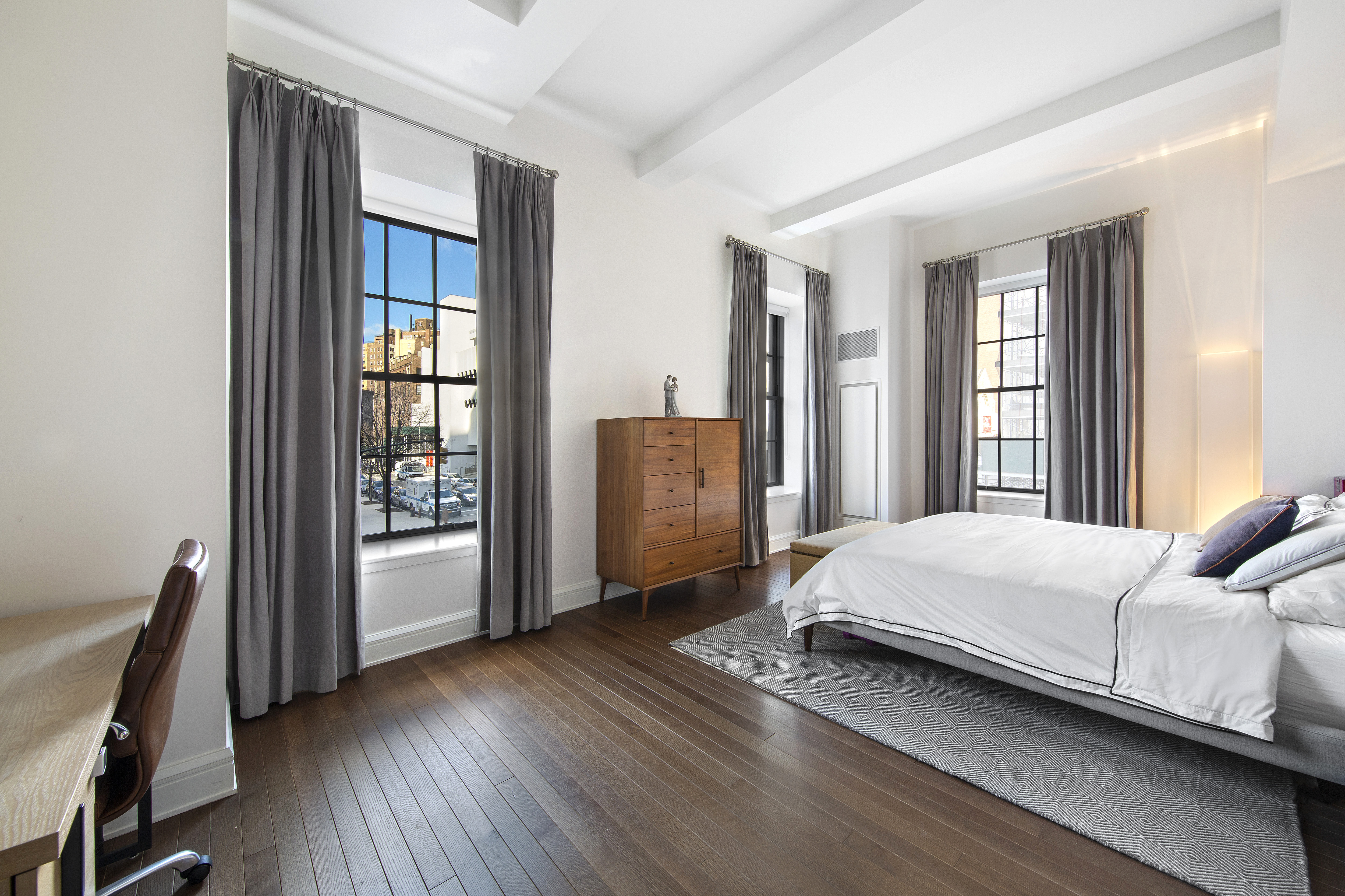 160 West 12th Street, Unit 28 Manhattan, NY 10011 - Photo 4 of 9 a living room with a bed furniture and a window