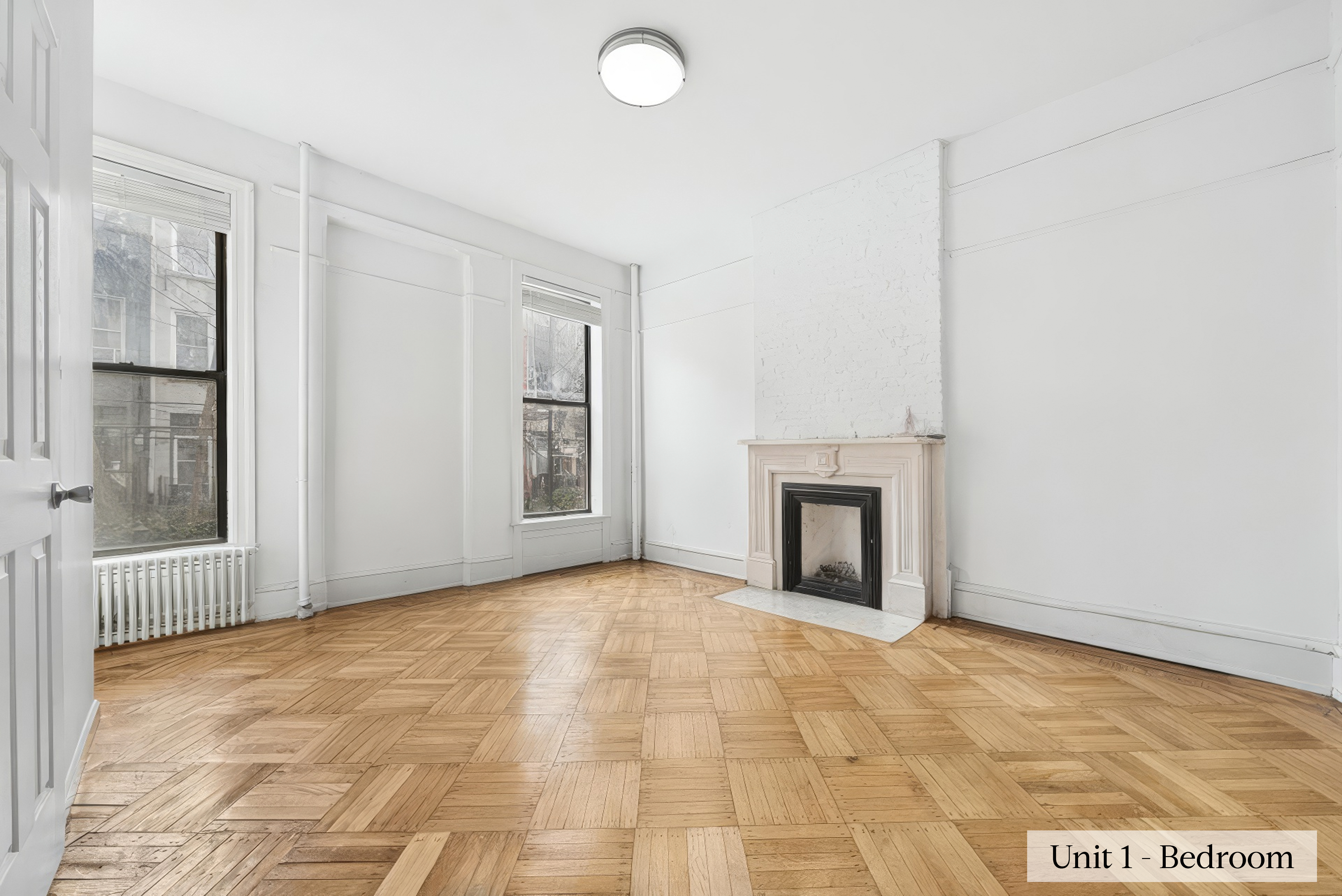 460 9th Street Brooklyn, NY 11215 - Photo 8 of 24 a view of an empty room with a fireplace and a window