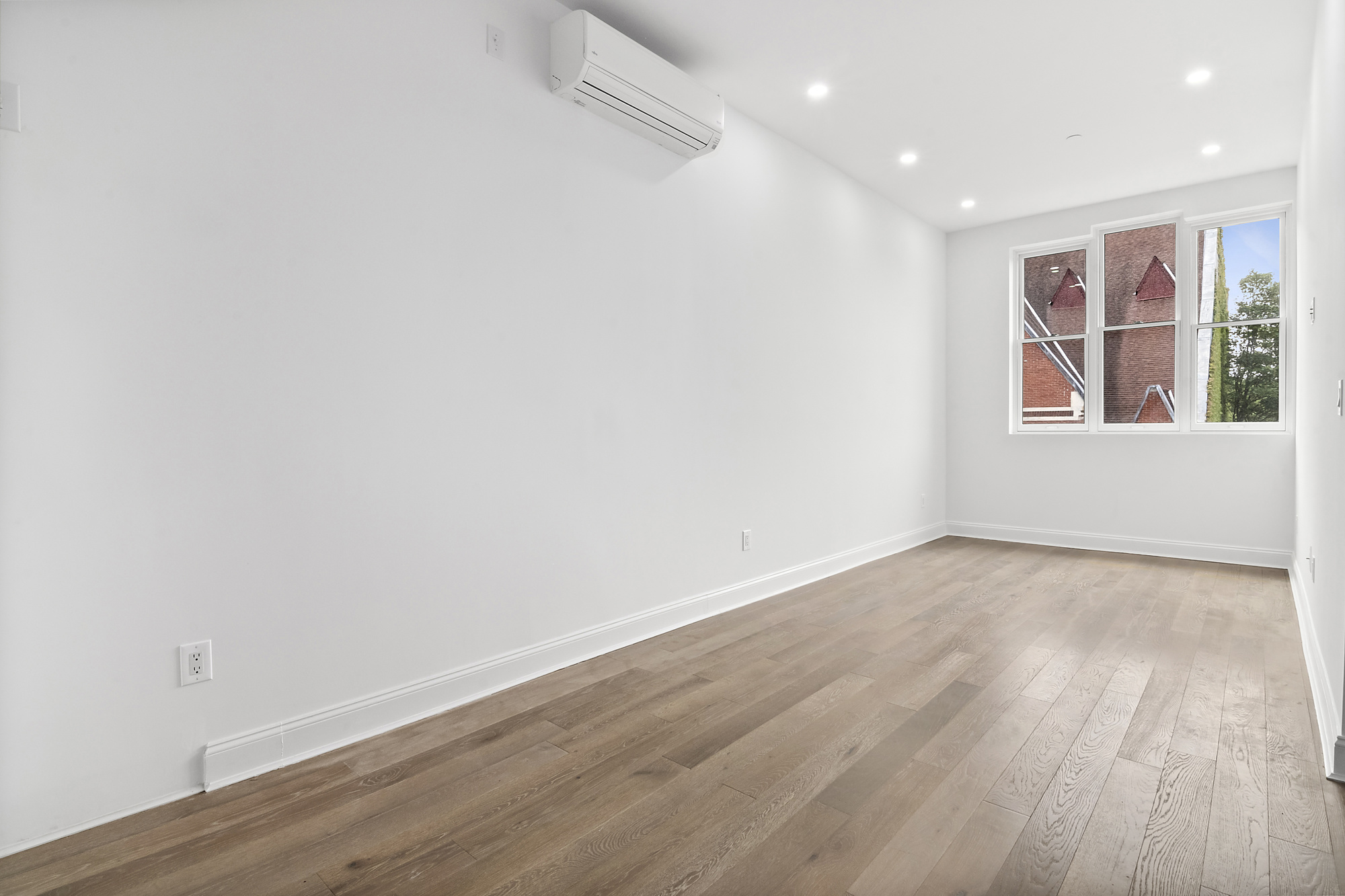 467 Tompkins Avenue, Unit 3A Brooklyn, NY 11216 - Photo 7 of 12 an empty room with wooden floor and windows