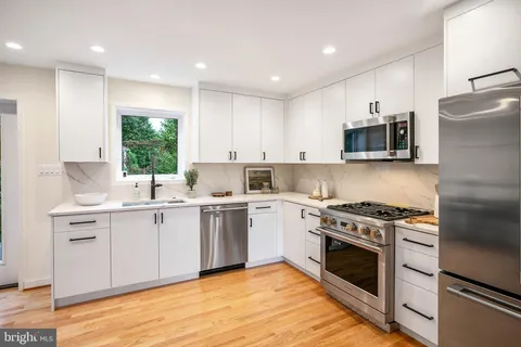 a kitchen with a stove a sink and a microwave