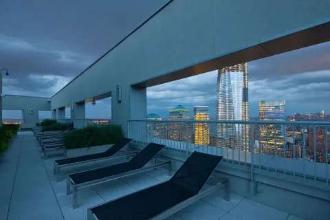 a view of a chairs and table in the balcony