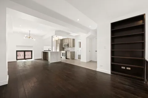a view of an empty room with a cabinet and a window