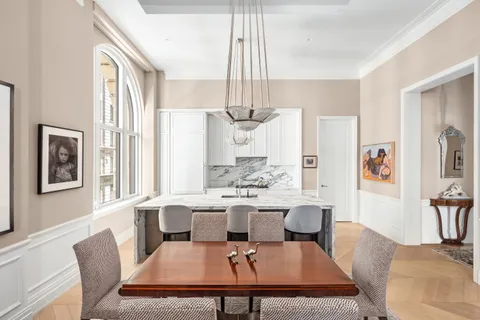 a living room with furniture a chandelier and a table