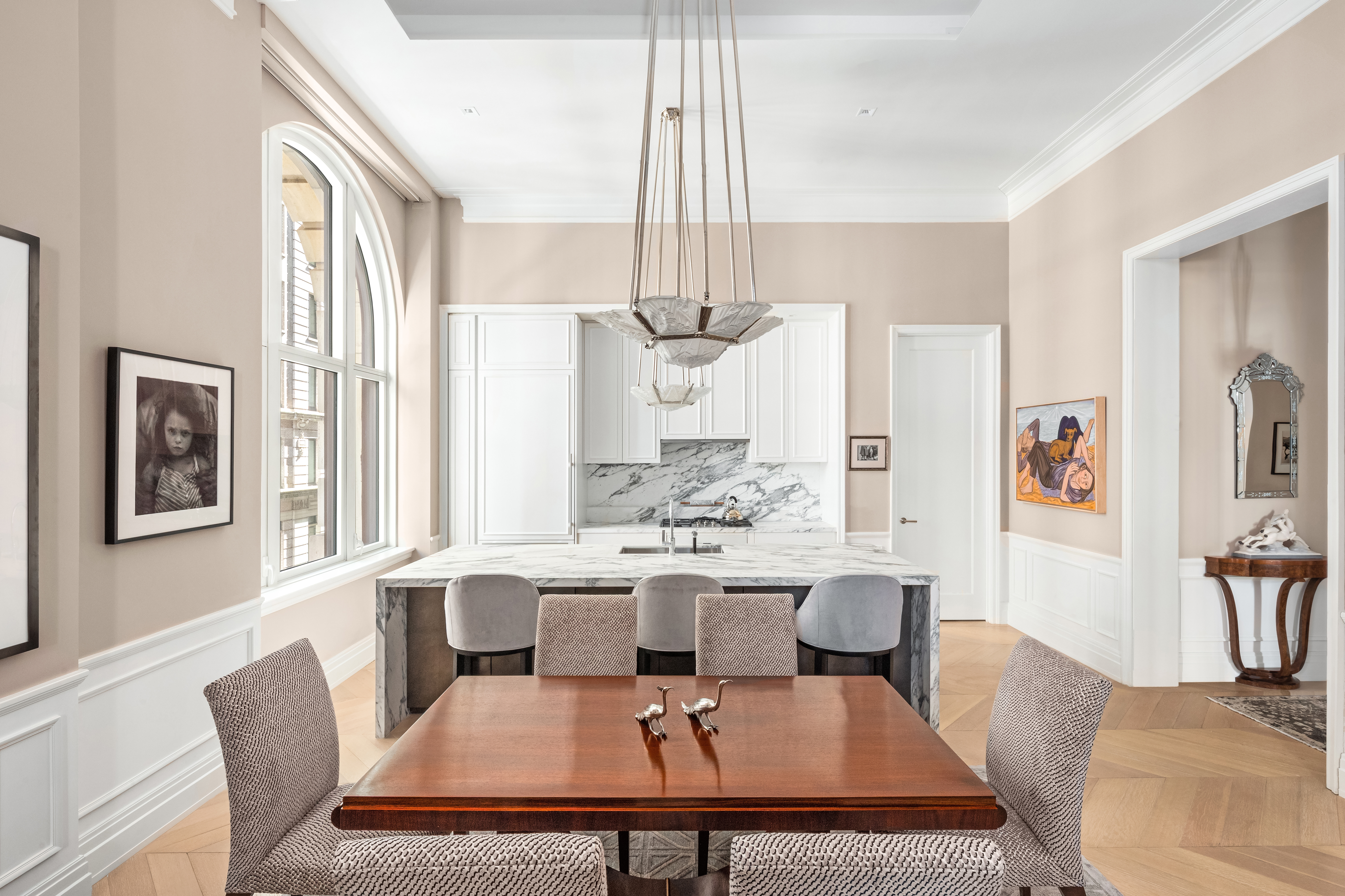 108 Leonard Street, Unit 4A Manhattan, NY 10013 - Photo 4 of 18 a living room with furniture a chandelier and a table