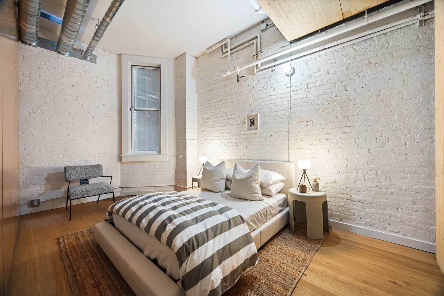 a bedroom with a bed and chair