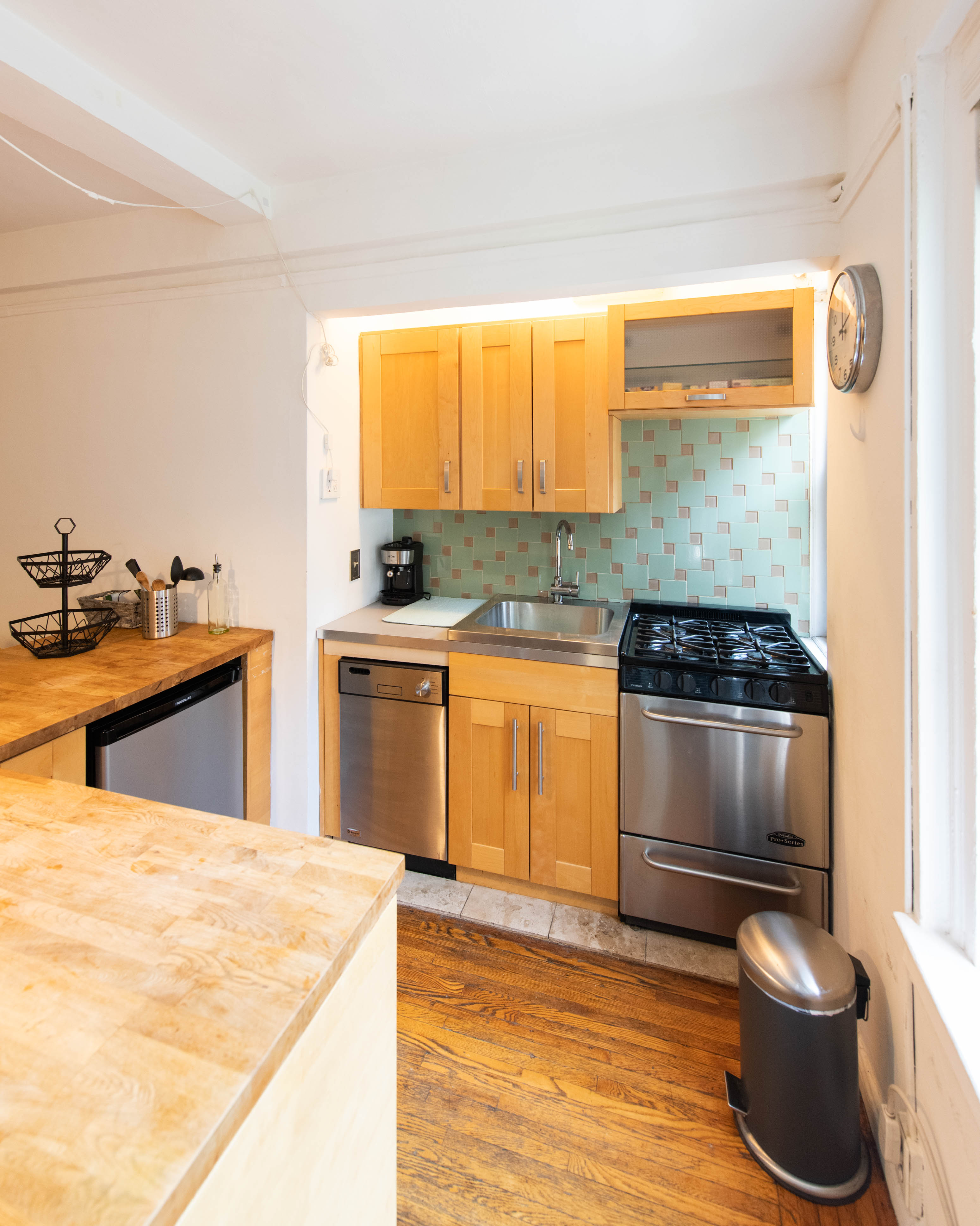 339 East 58th Street, Unit 5B Manhattan, NY 10022 - Photo 7 of 13 a kitchen with a stove a sink and a microwave