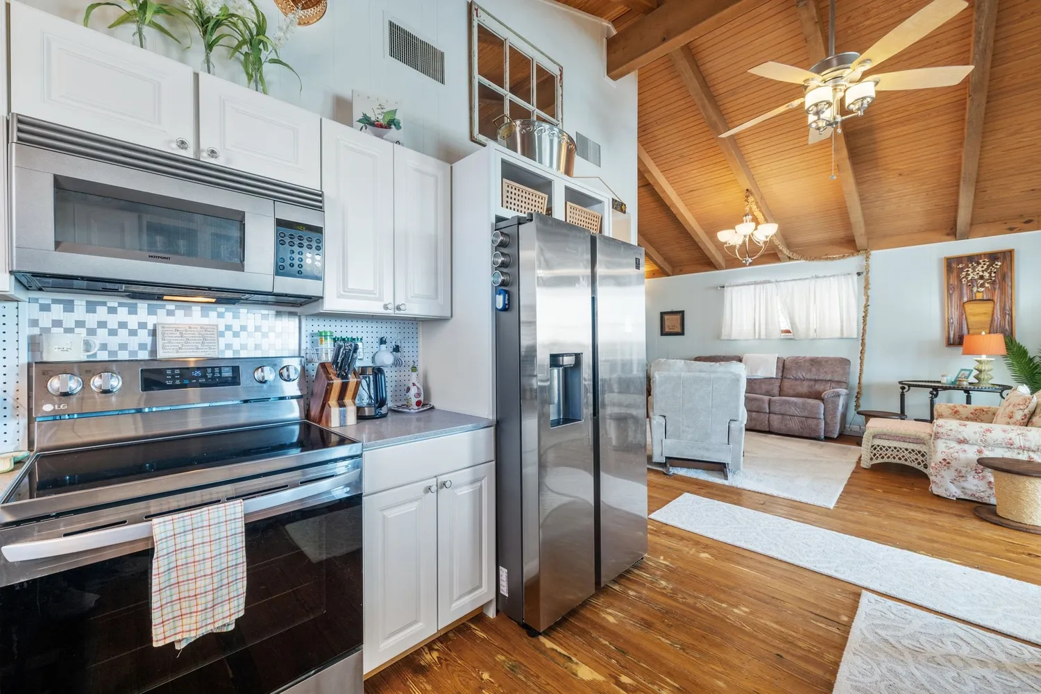 a kitchen with stainless steel appliances granite countertop a refrigerator a stove and a sink