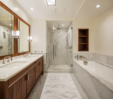 a spacious bathroom with a double vanity sink large mirror and a bathtub