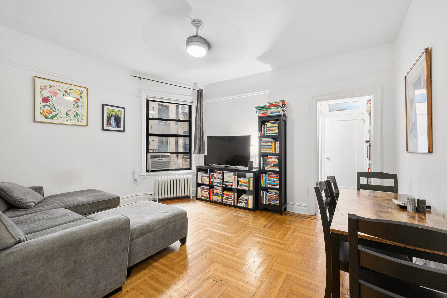 255 Eastern Parkway, Unit C5 Brooklyn, NY 11238 - Photo 1 of 9 a living room with furniture and a flat screen tv