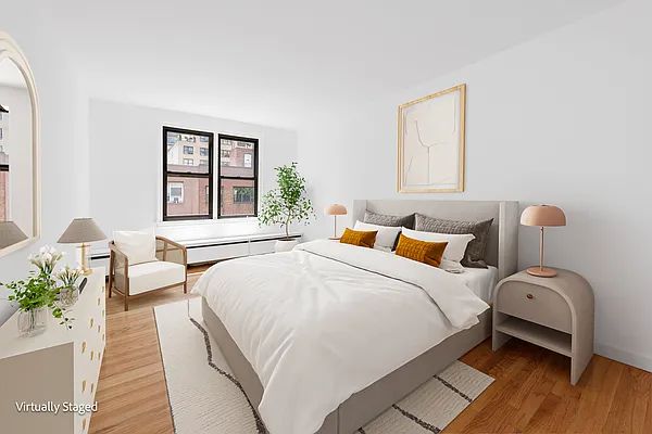 337 East 50th Street, Unit PH-E Manhattan, NY 10022 - Photo 4 of 7 a bedroom with a bed and wooden floor