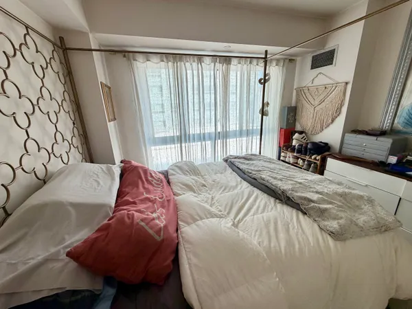 a bedroom with a bed and a window