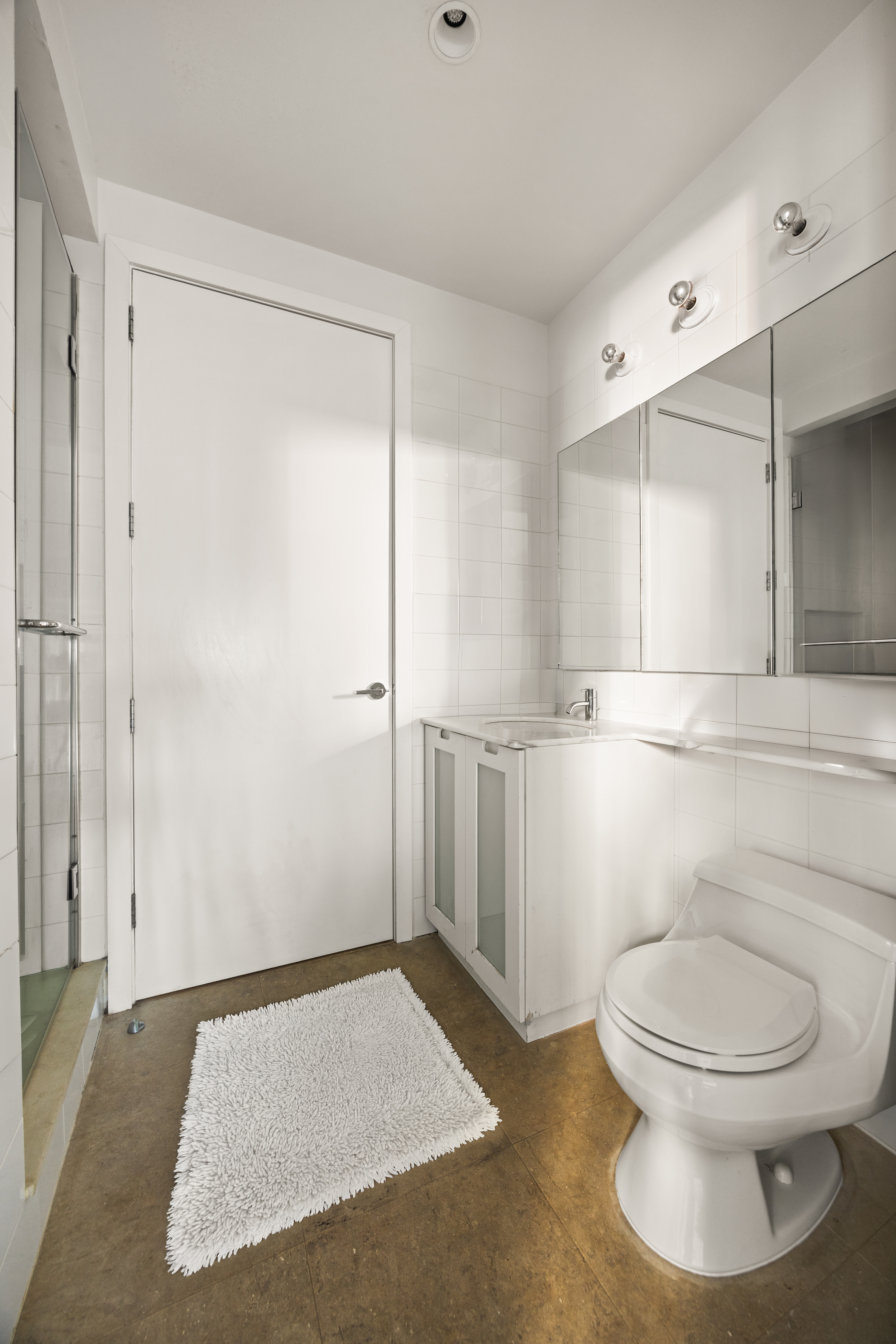 150 Nassau Street, Unit 17D Manhattan, NY 10038 - Photo 8 of 16 a bathroom with a toilet and a shower