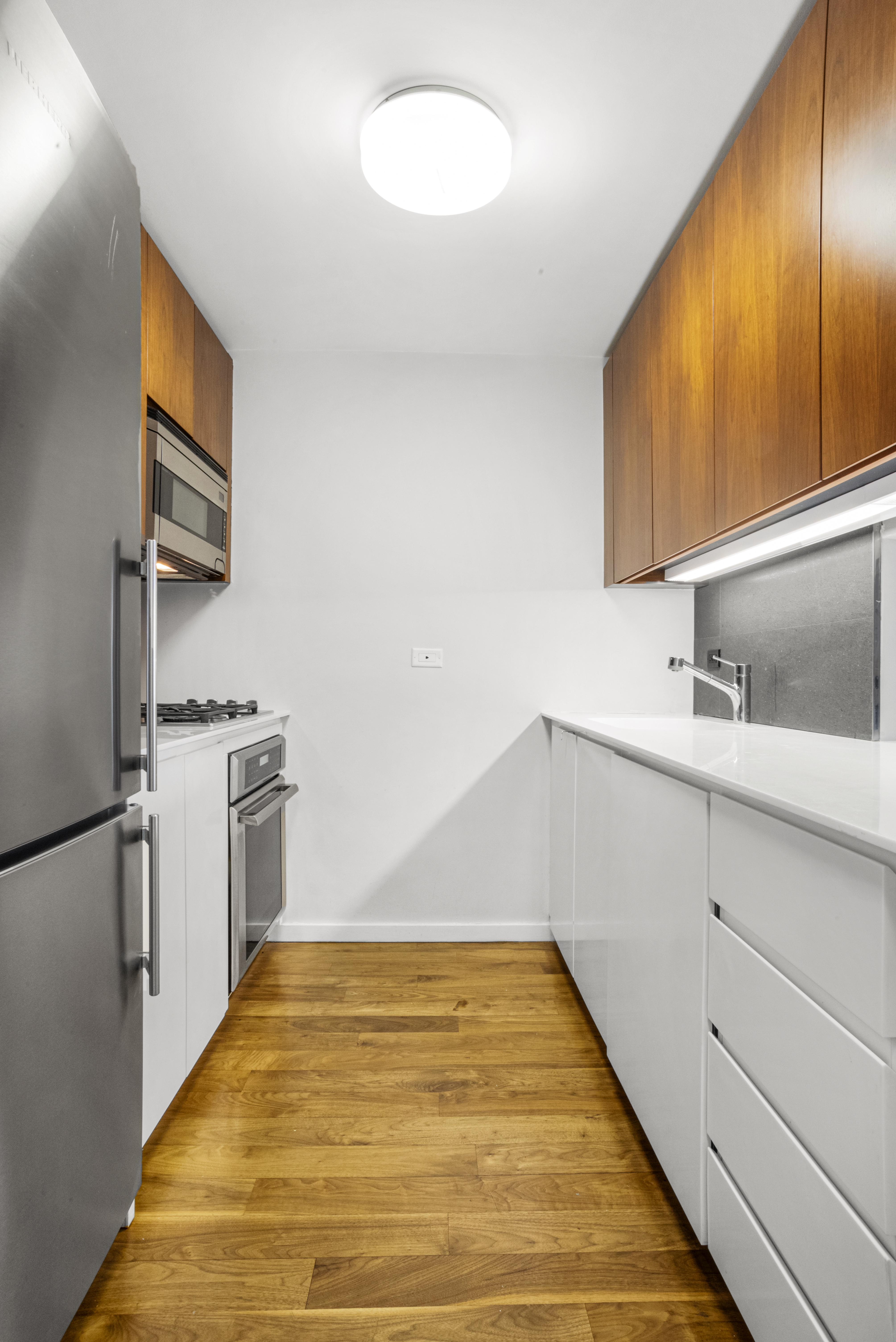 515 East 72nd Street, Unit 25E Manhattan, NY 10021 - Photo 3 of 11 a kitchen with a sink cabinets and stainless steel appliances