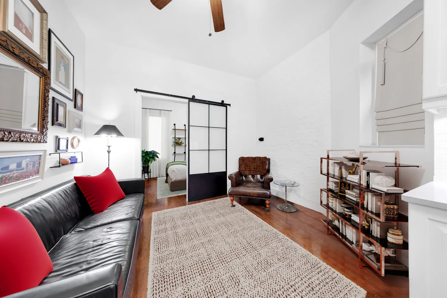a living room with furniture a rug and a window